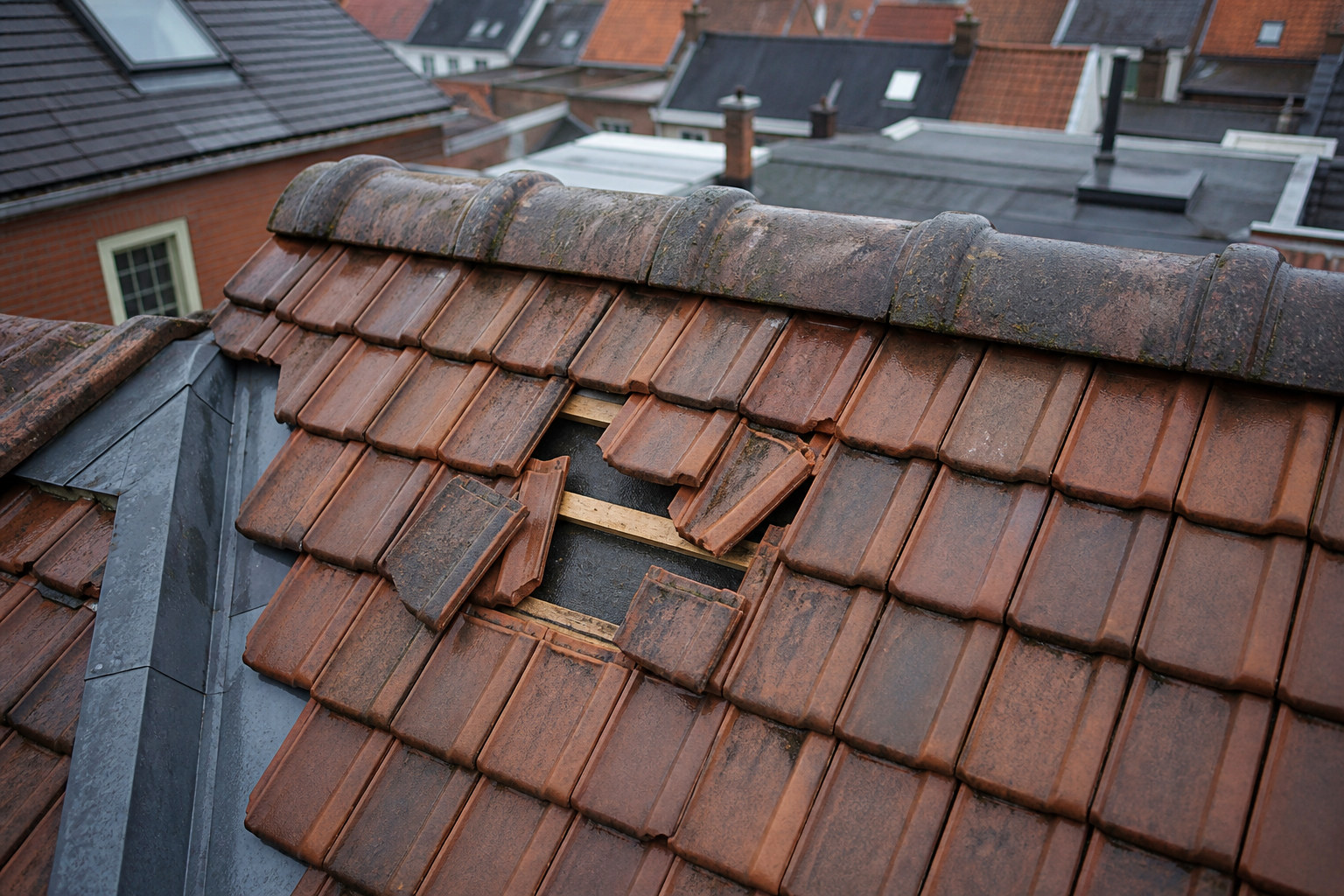 Detailbeeld van verschoven dakpannen na storm